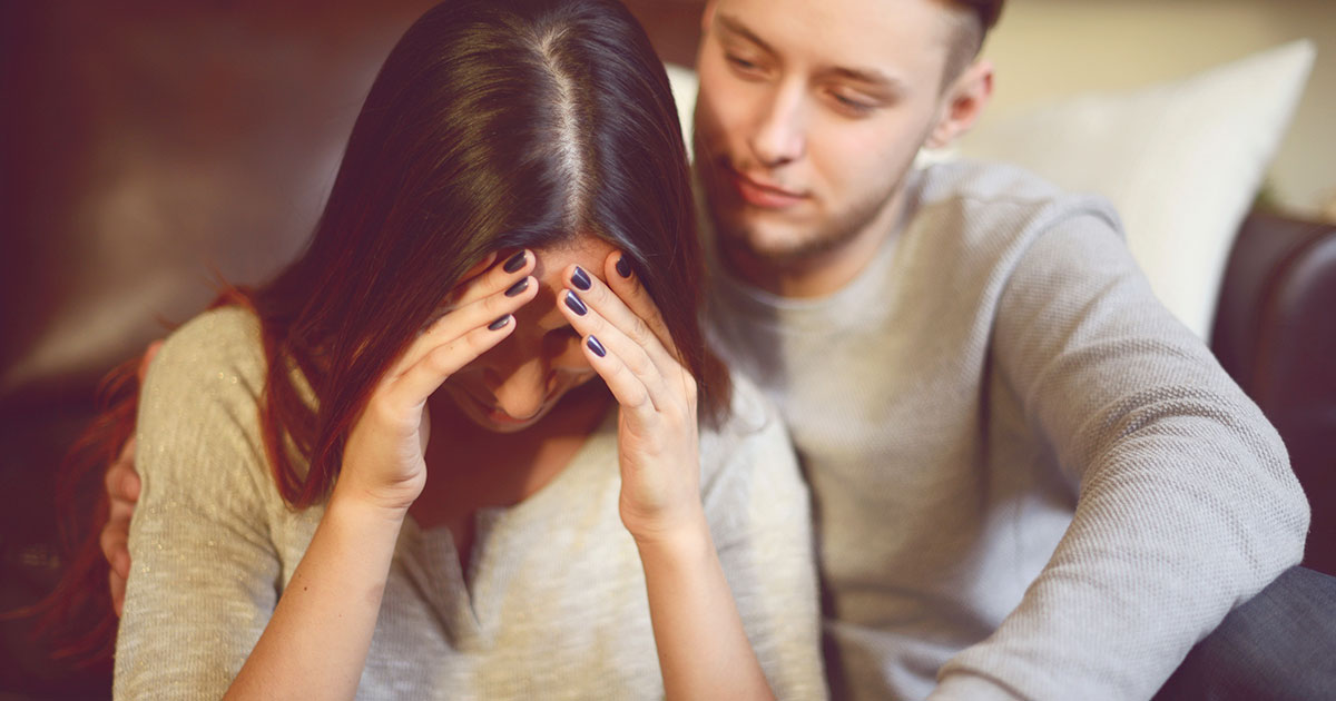 Sad girlfriend is being comforted by her boyfriend